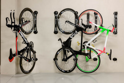 Three bikes stored vertically using Steady's folding bike racks.