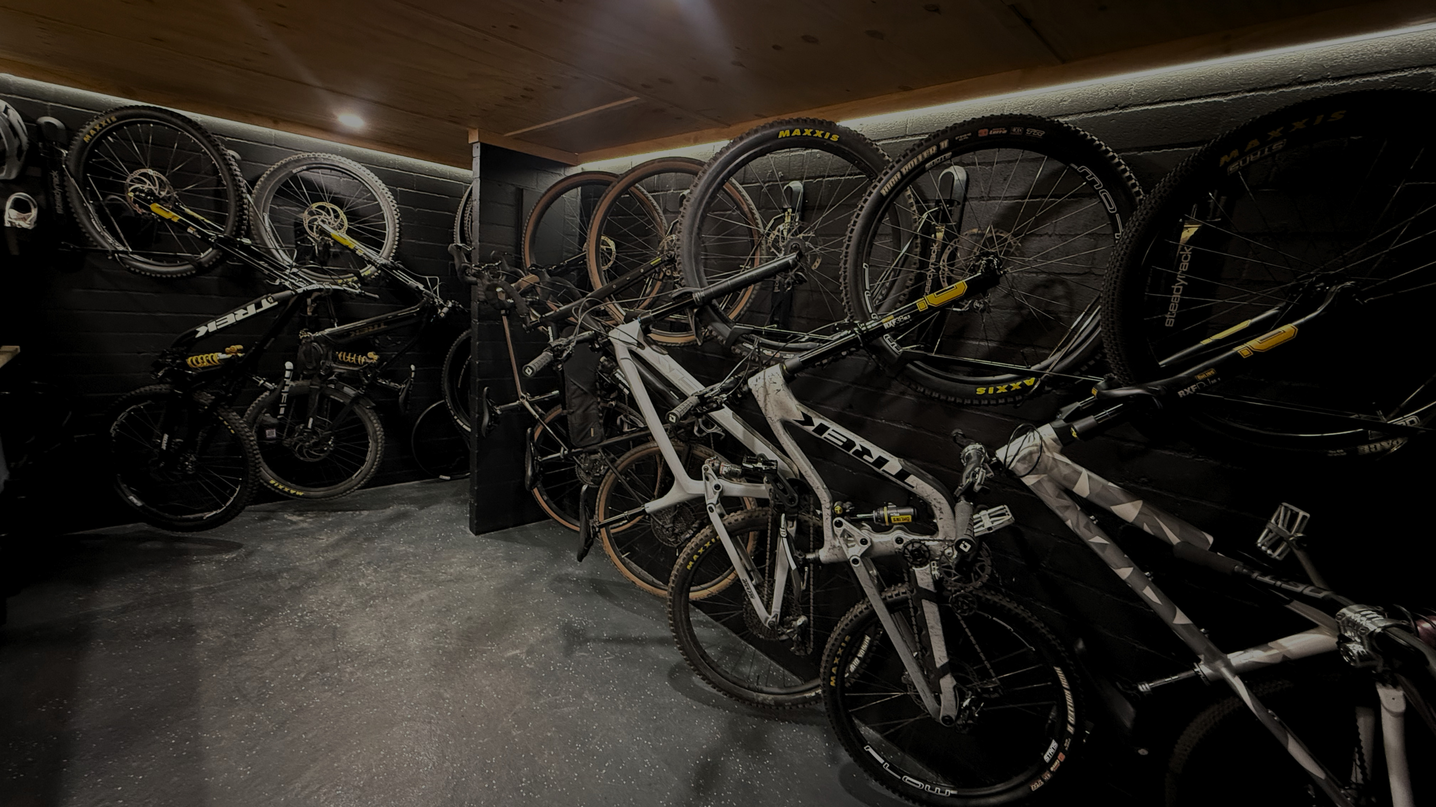 Bicycles stored in a dimly lit garage or storage area.