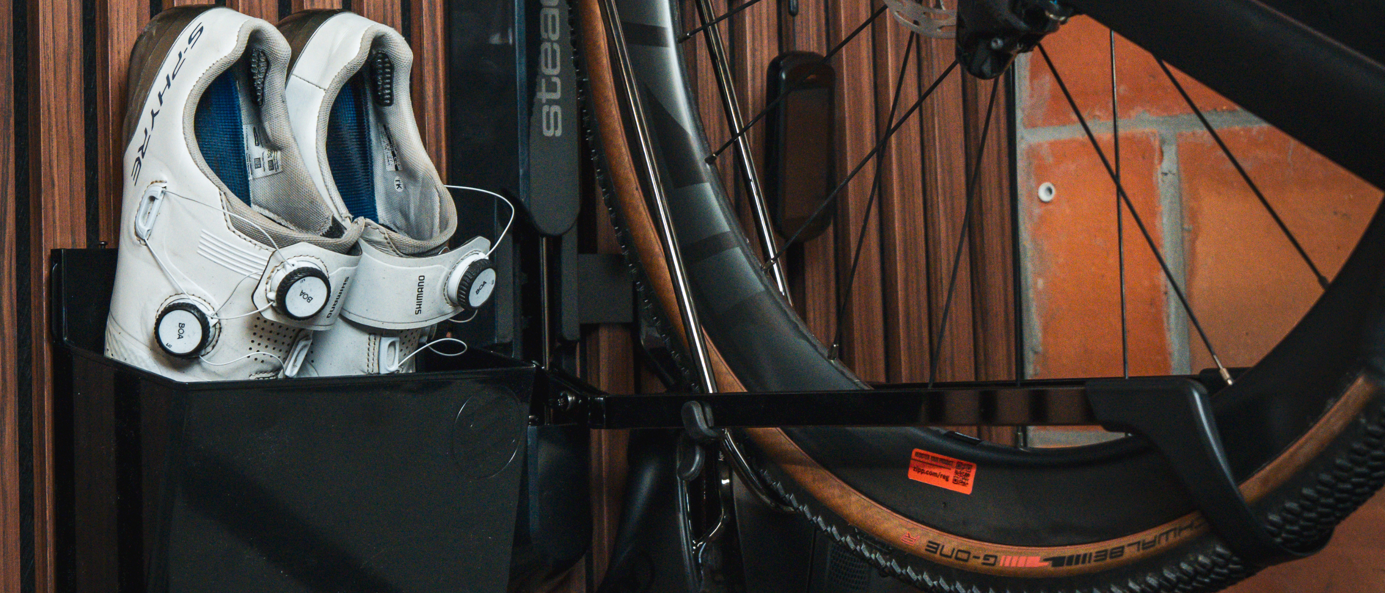 Bicycle mounted on a wall bracket with a wooden background