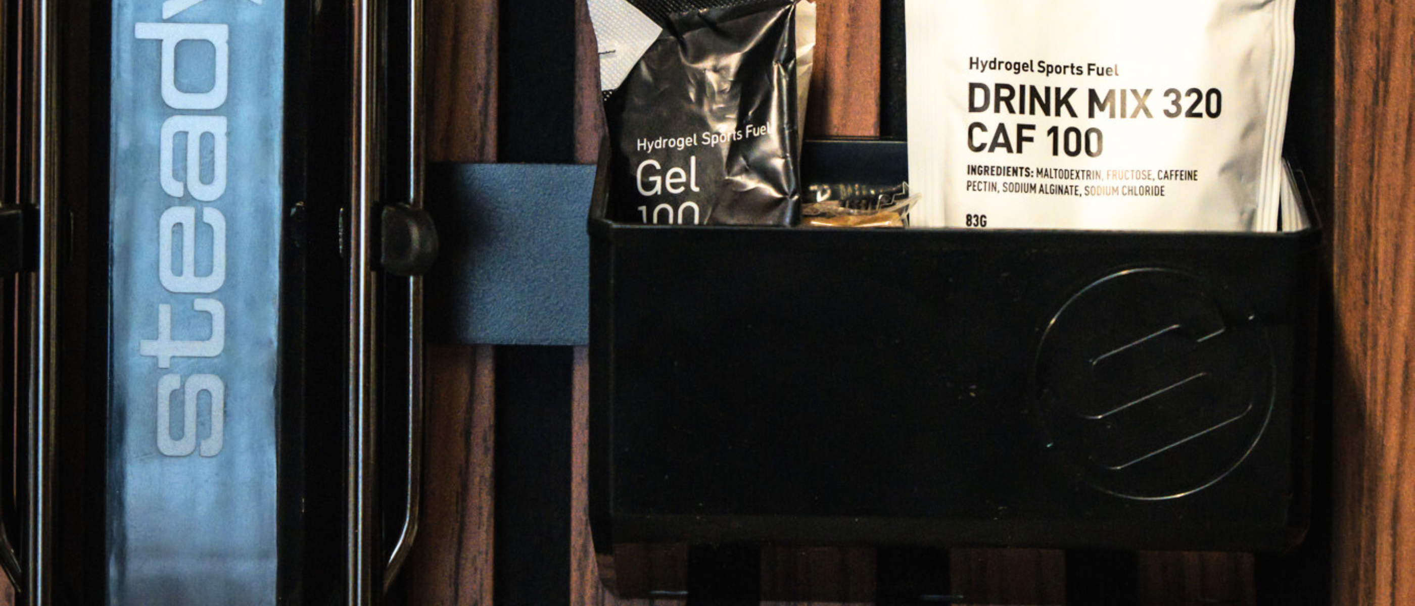 Sports nutrition products stored in a storage bin.