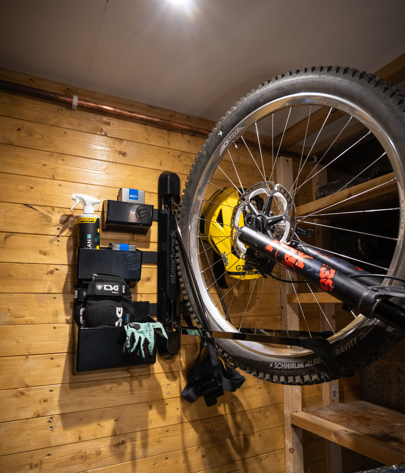 Bicycle mounted on a wall rack in a wooden room