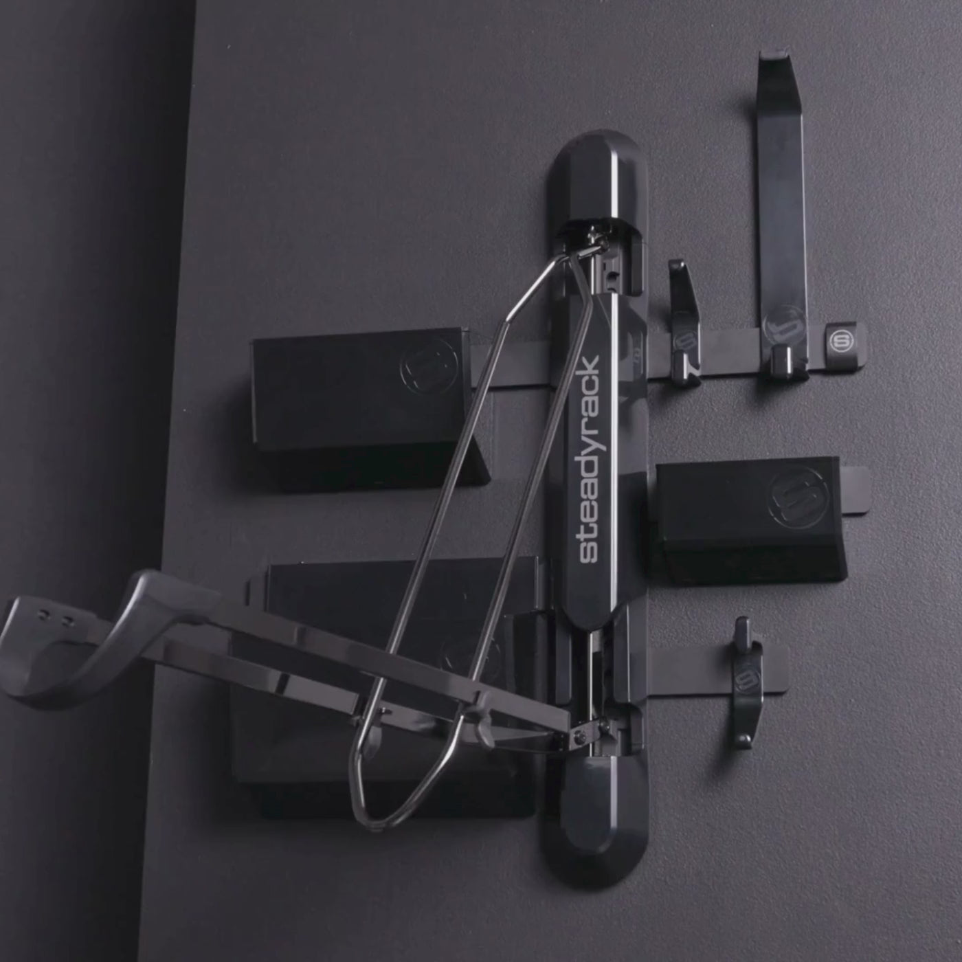 Video of a bike rack with black gloss finish storage bins and hooks
